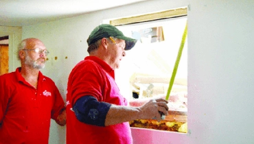 Mr. Handyman repairmen measuring window