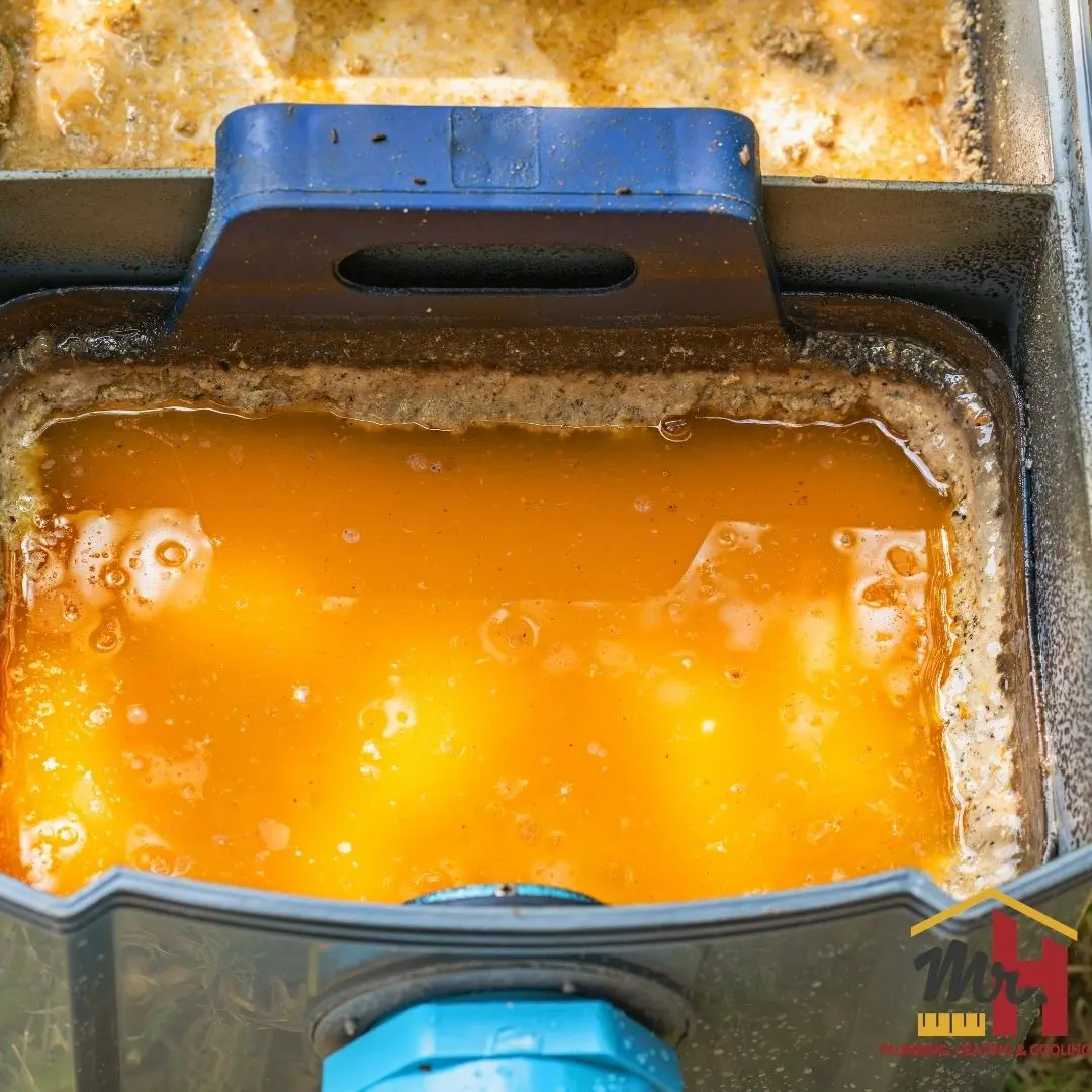 Overfilled restaurant grease trap requiring maintenance in South Bend Indiana commercial kitchen.