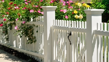 White fence with flowers White fence with colorful flowers