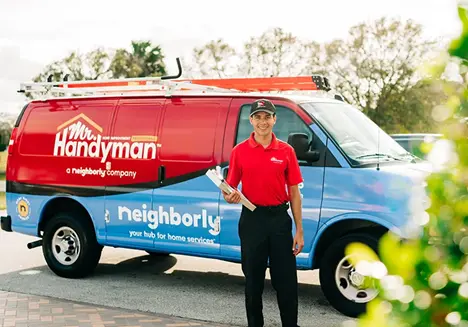 Mr. Handyman tech in front of work van before home repair service